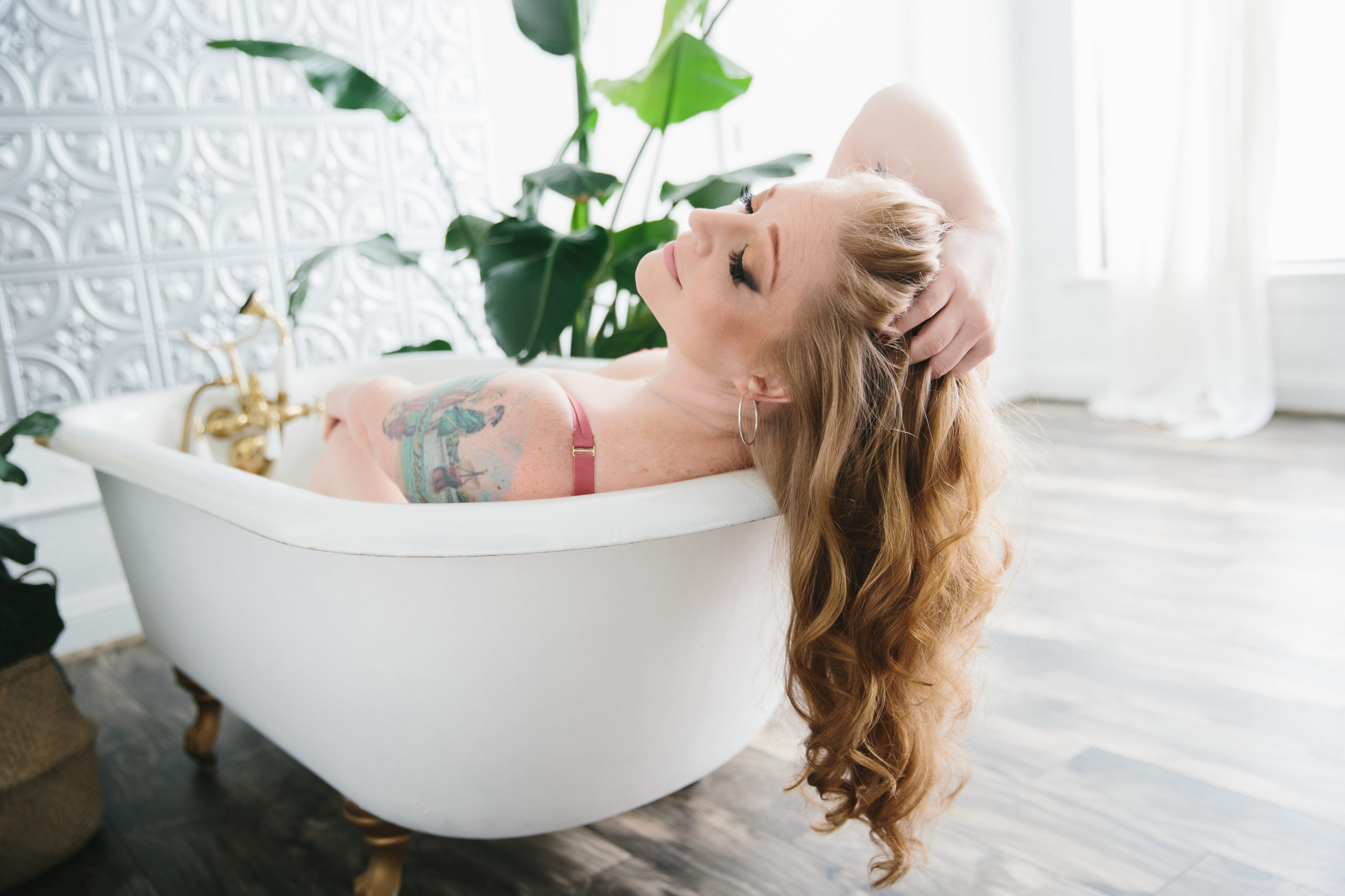 Boudoir Portrait, brunette in bathtub with flowers; Lindsay Hite