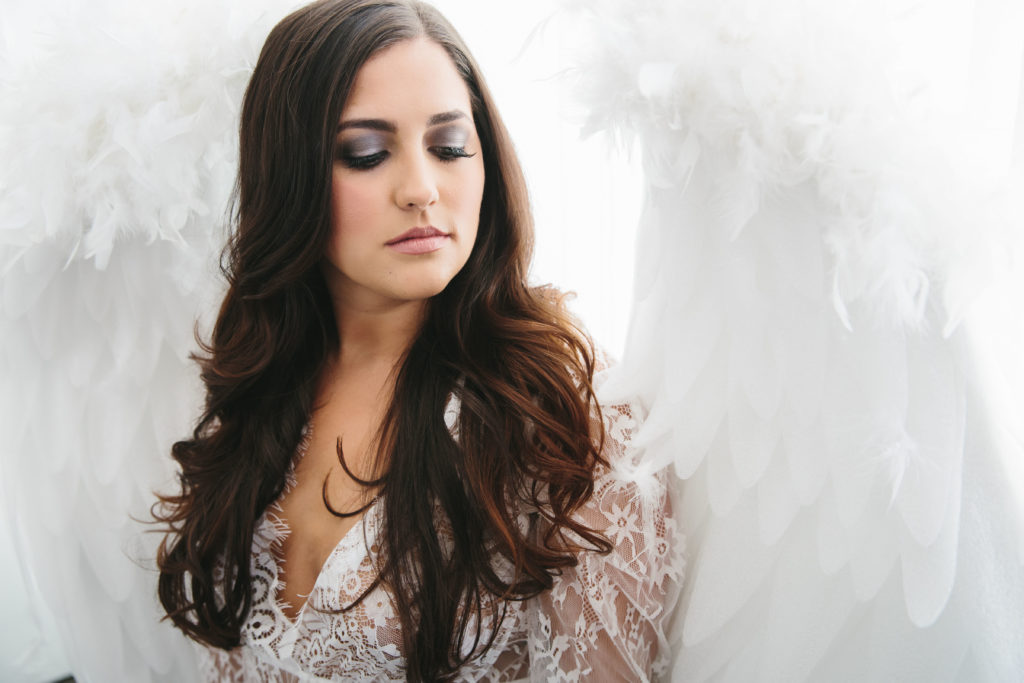 brunette in lace lingerie and angel wings; women's empowerment photography by Lindsay Hite