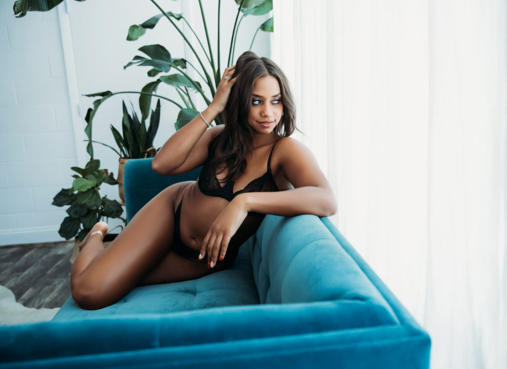 boudoir photography boston, woman in black lingerie on teal couch; empowering luxury portrait experience; Lindsay Hite Photography