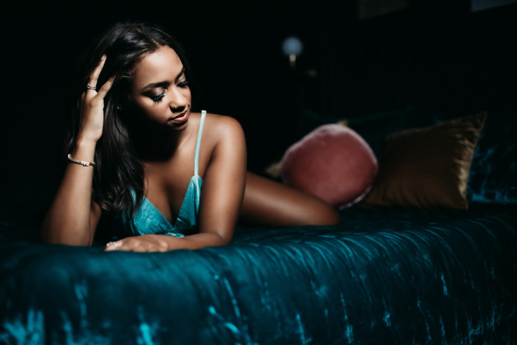 woman in teal lingerie on a teal bed: empowering luxury portrait experience; Lindsay Hite Photography