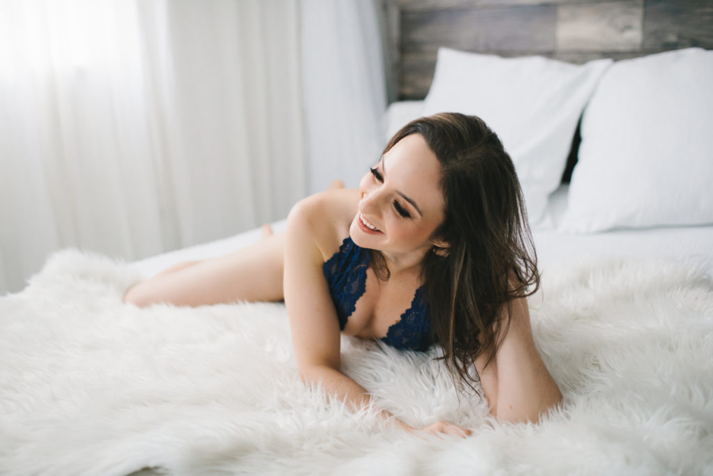 woman in blue lace bodysuit on white fur lined bed, boudoir photography by Lindsay Hite, a pivotal moment