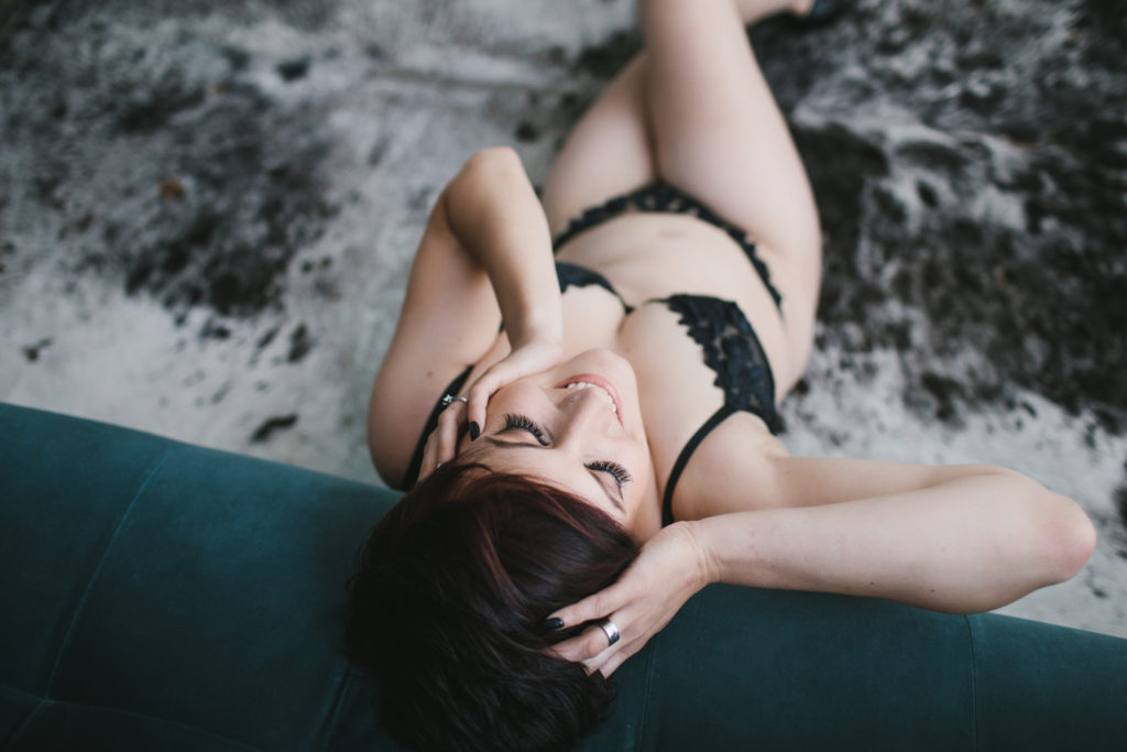 short haired woman in black lingerie on teal sofa: A Gift For Yourself: Boudoir Photography by Lindsay Hite