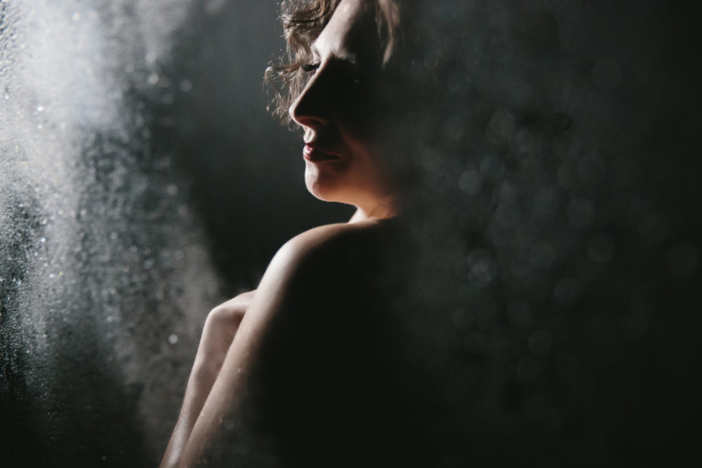 Woman in dark shower scene, boudoir photography by Lindsay Hite