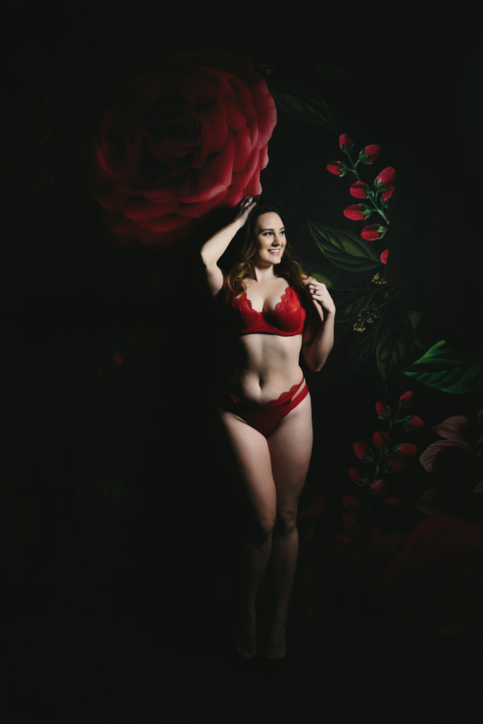 Woman in 2 piece red lingerie against a rose tapestry background; accept your body now, boudoir photography by Lindsay Hite