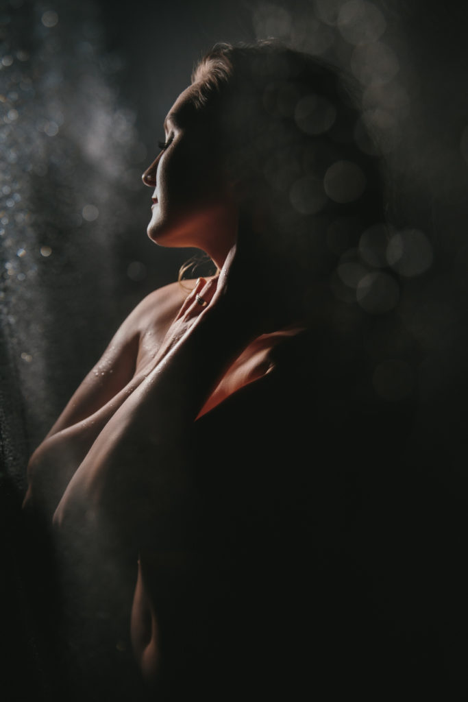 Portrait of nude woman in a dark shower scene, by Lindsay Hite