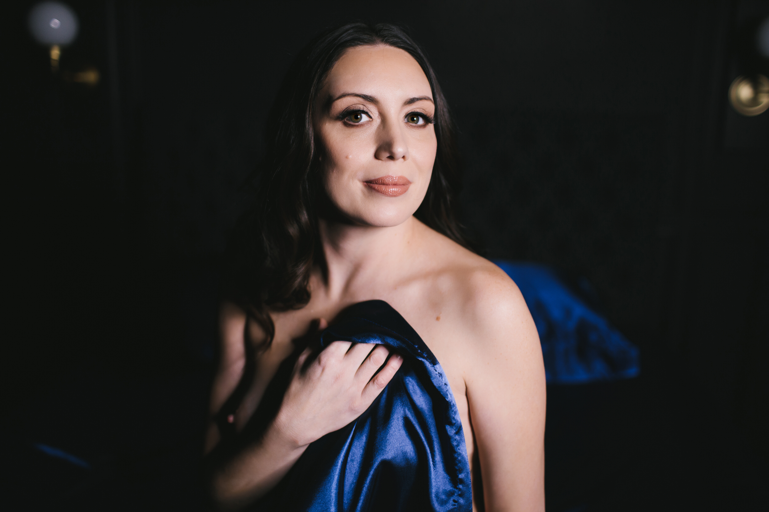 Woman in the nude in blue satin sheets: empowerment photography by Lindsay Hite