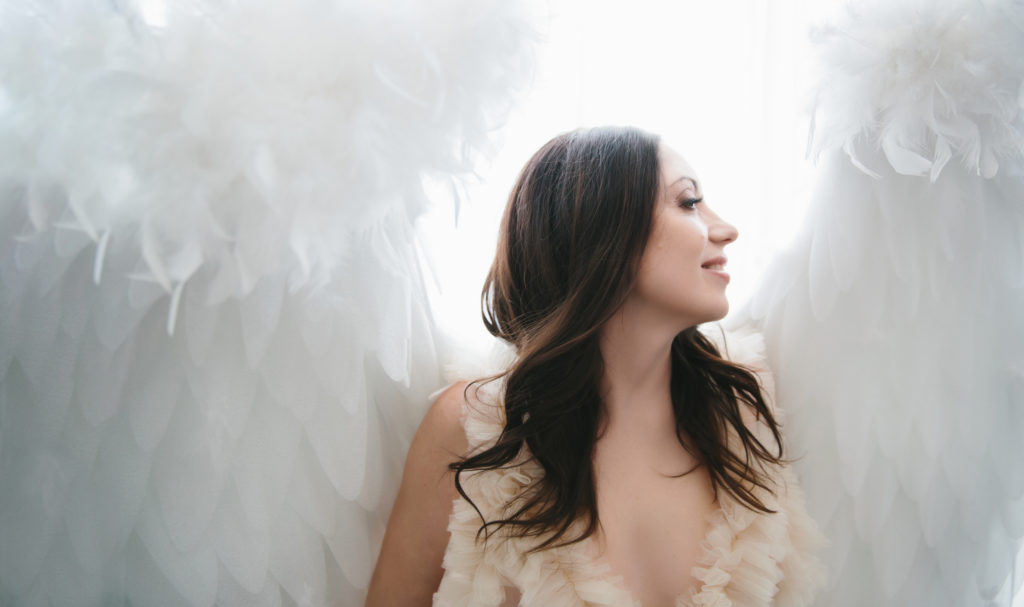 Woman in blush colored dress and angel wings; empowerment photography by Lindsay Hite
