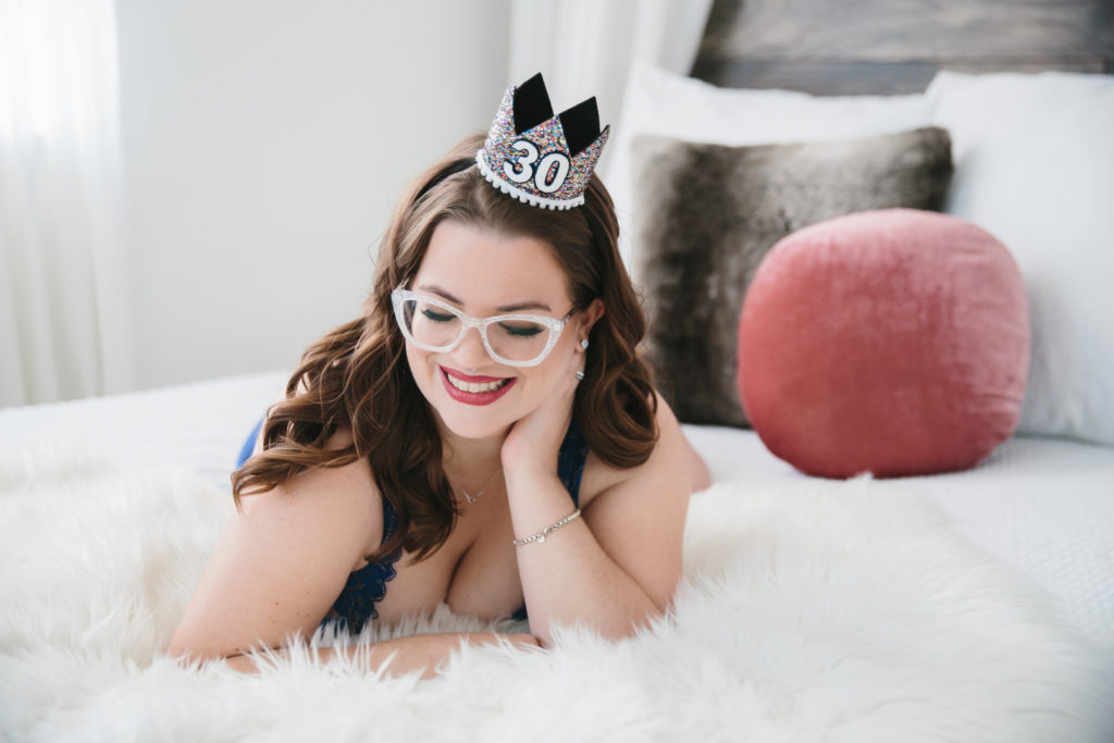 woman on fur lined bed with birthday crown, photography by Lindsay Hite