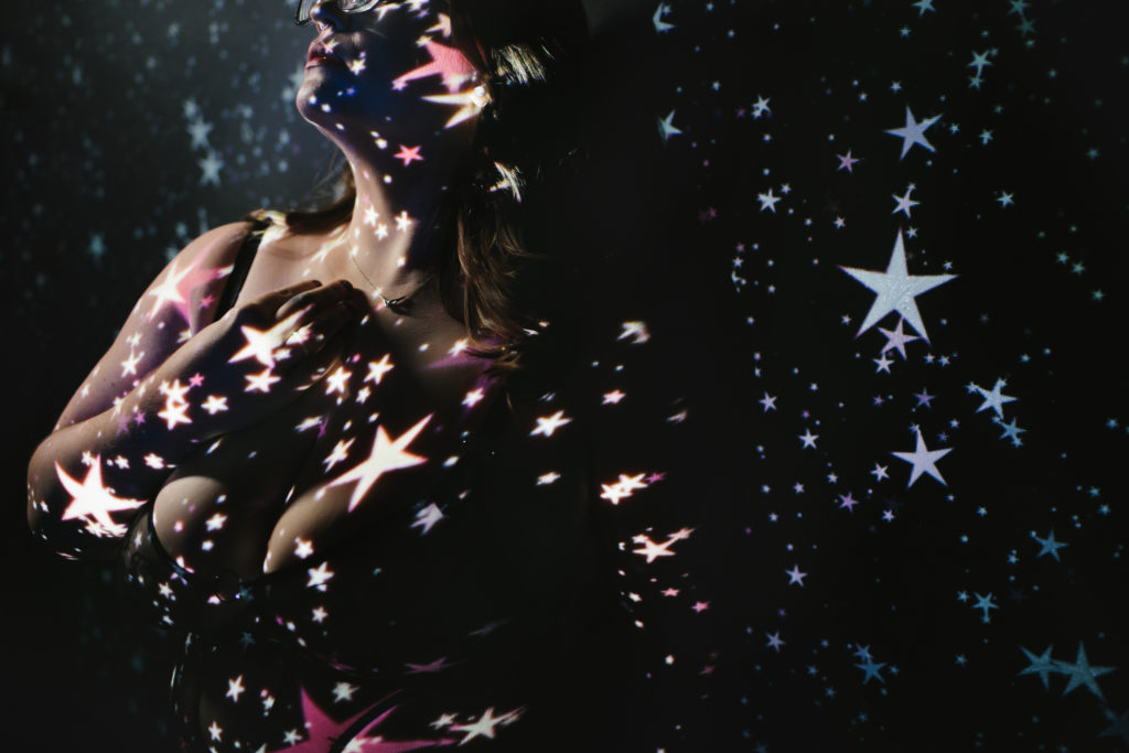 Woman in lingerie with stars projected; boudoir photography by Lindsay HIte
