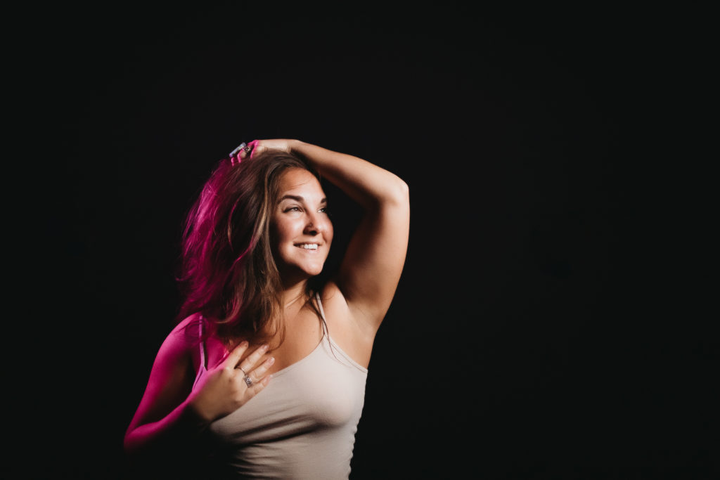 Woman in tank top with a dark background.  Learning to Live an Embodied Life.  Photography by Lindsay Hite

