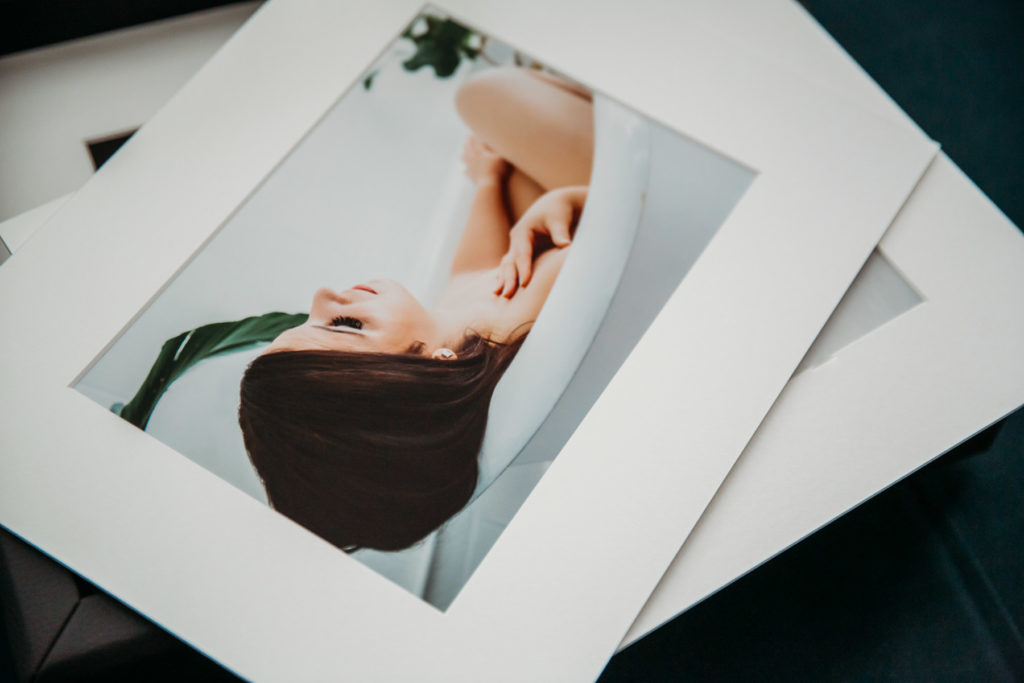Matted boudoir photography prints of a woman in a white bathtub; boudoir photography by Lindsay Hite