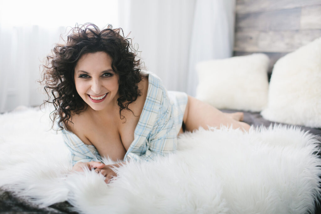 woman in button down shirt on white fur-lined bed, Bright Boudoir Photography Scenes by Lindsay Hite