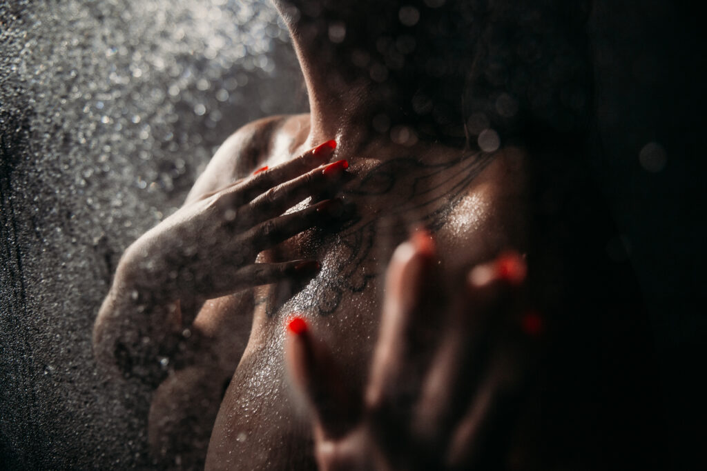 image of woman's chest in the shower.  dark and moody boudoir scenes by Lindsay Hite