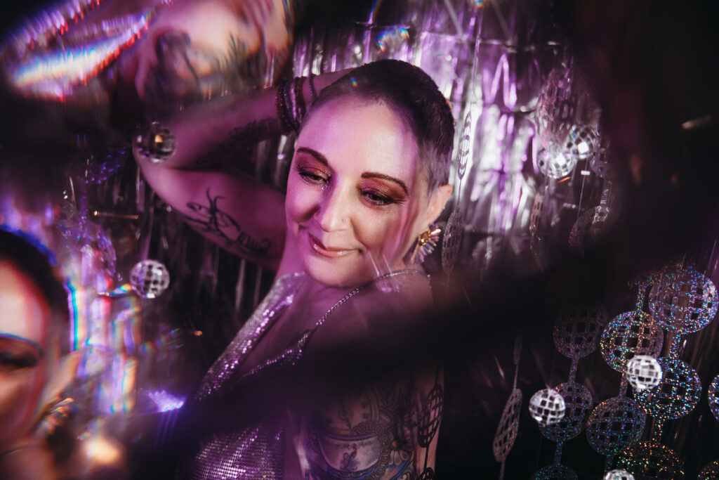 Woman in disco-ball set at Show Your Spark magazine launch.  Photography by Lindsay Hite
