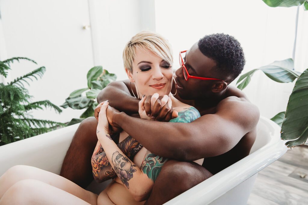 Portrait of a couple in a white garden bathtub.  Decadent bathtub poses by Lindsay Hite. 