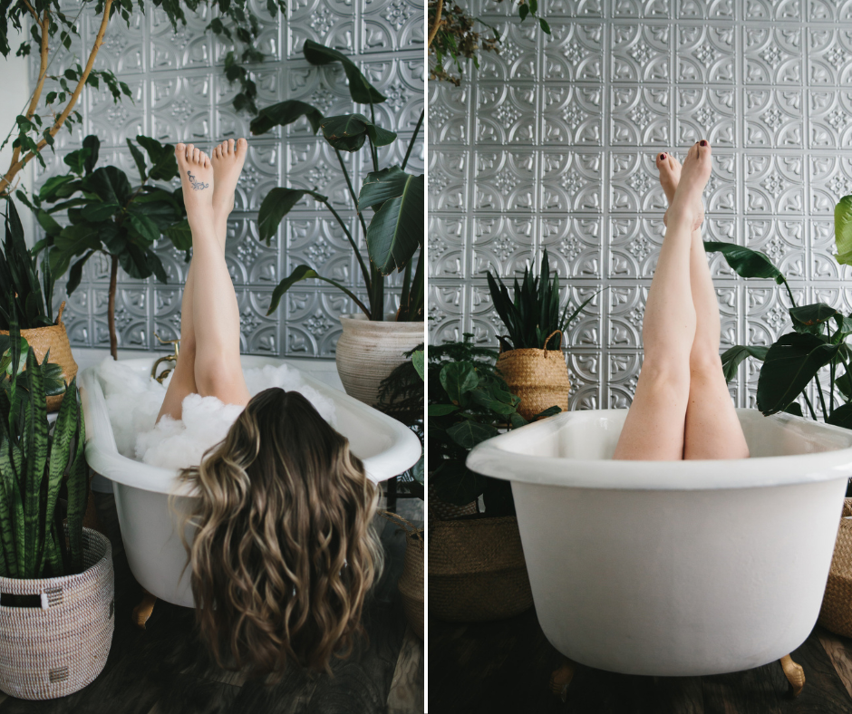 Side by side image of two women in a bathtub with ankles cross against a silver backdrop.  Boudoir photography by Lindsay Hite. 