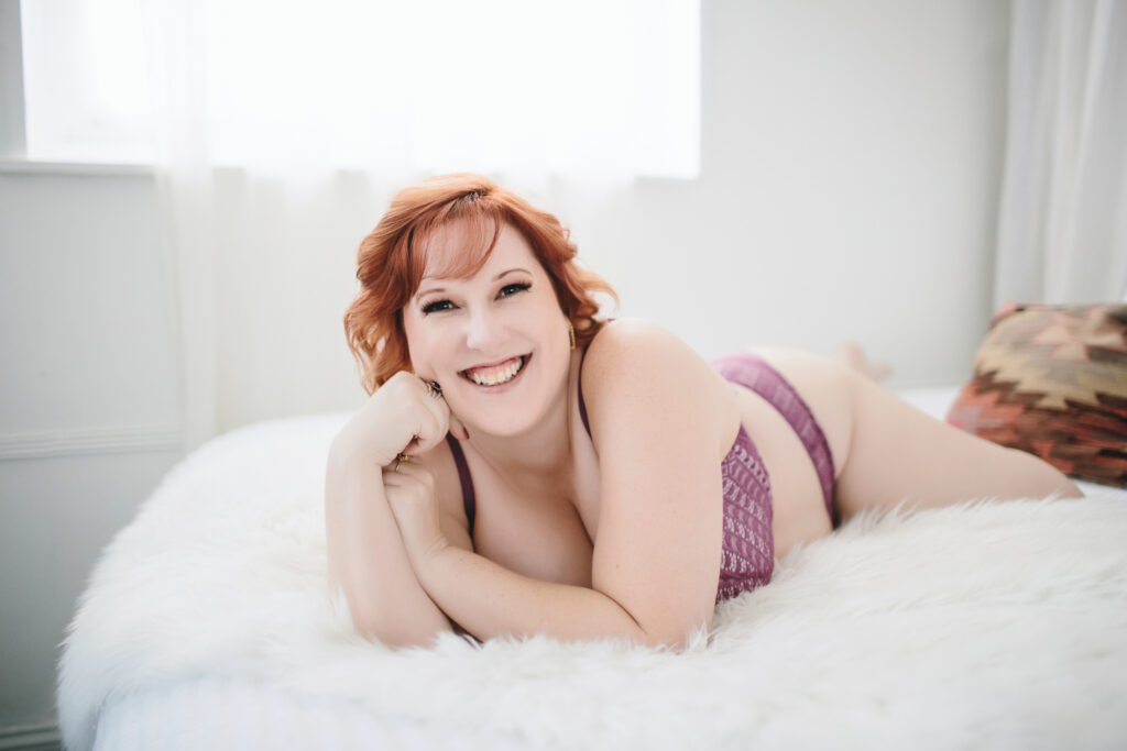 Woman in purple bra set on a white fur-lined bed.  Photography by Lindsay Hite. 