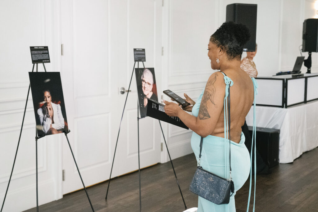 Picture of a Fierce After Forty Project Participant with her photo from the Gallery Show