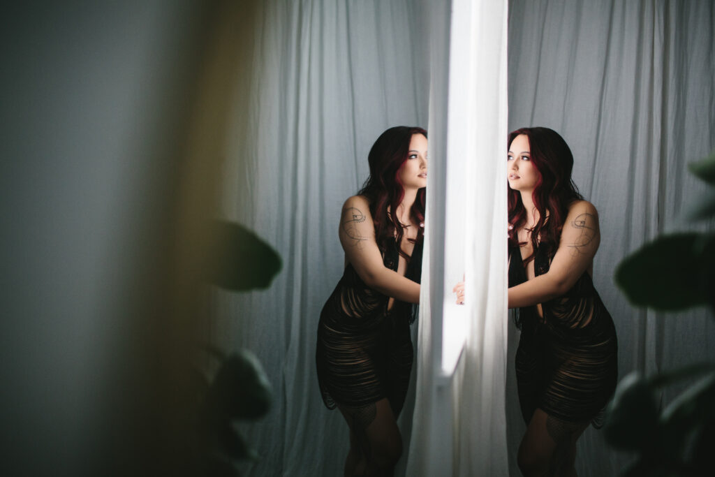 Image of a woman looking into a mirror and committed to personal growth.  Photography by Lindsay Hite