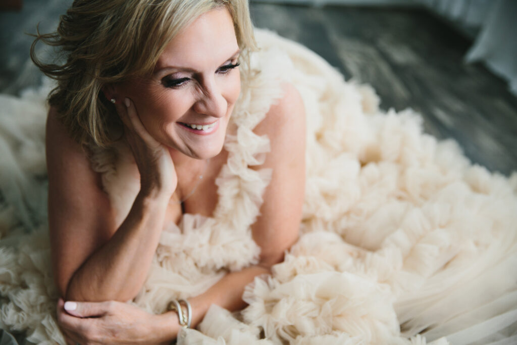 Woman leaning on her hand in a blue toile dress.  Photography by Lindsay Hite