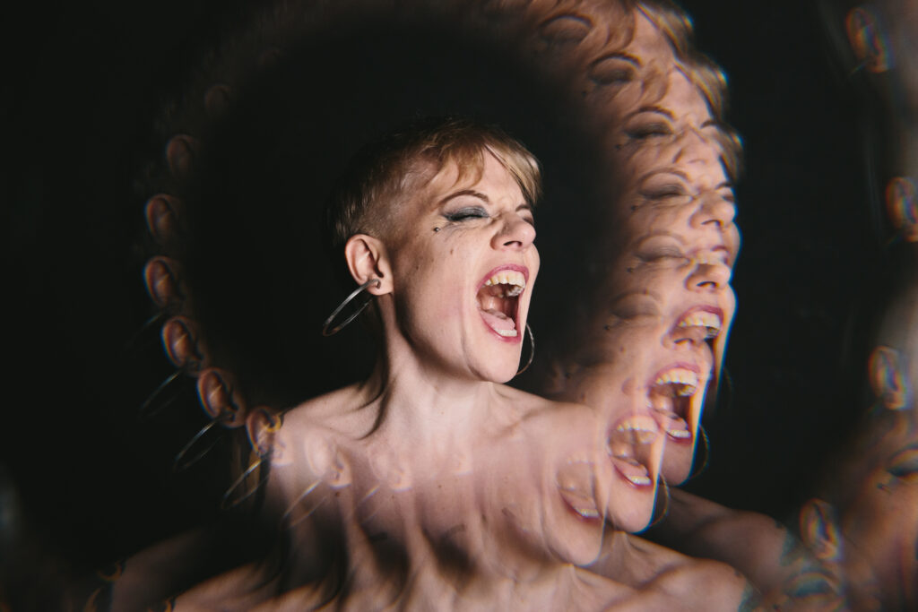 Artistically overlayed image of a woman screaming.  Photography by Lindsay Hite. 