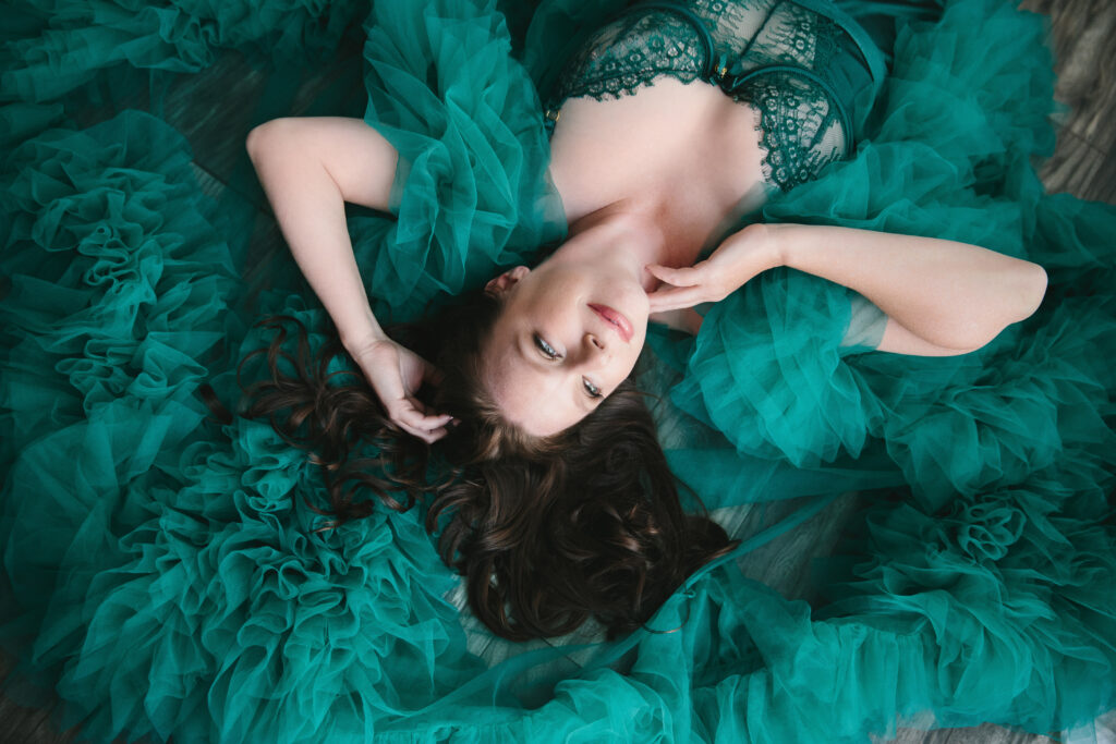 Woman in teal lingerie and robe laying on the floor.  Photography Lindsay Hite