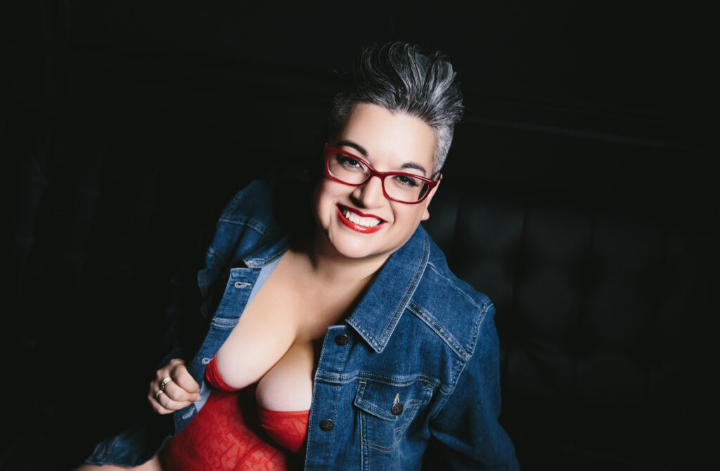 Woman in red lingerie and jean jacket powerful and confident in her own skin. Photography by Lindsay Hite