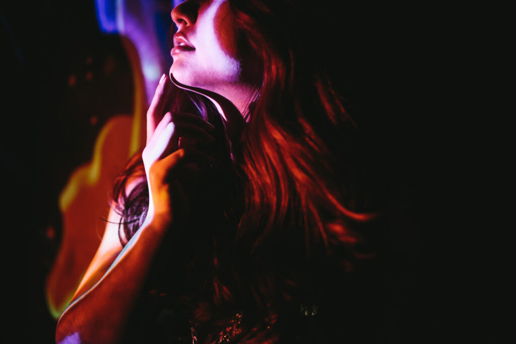 Woman with black backdrop and artistic photography.