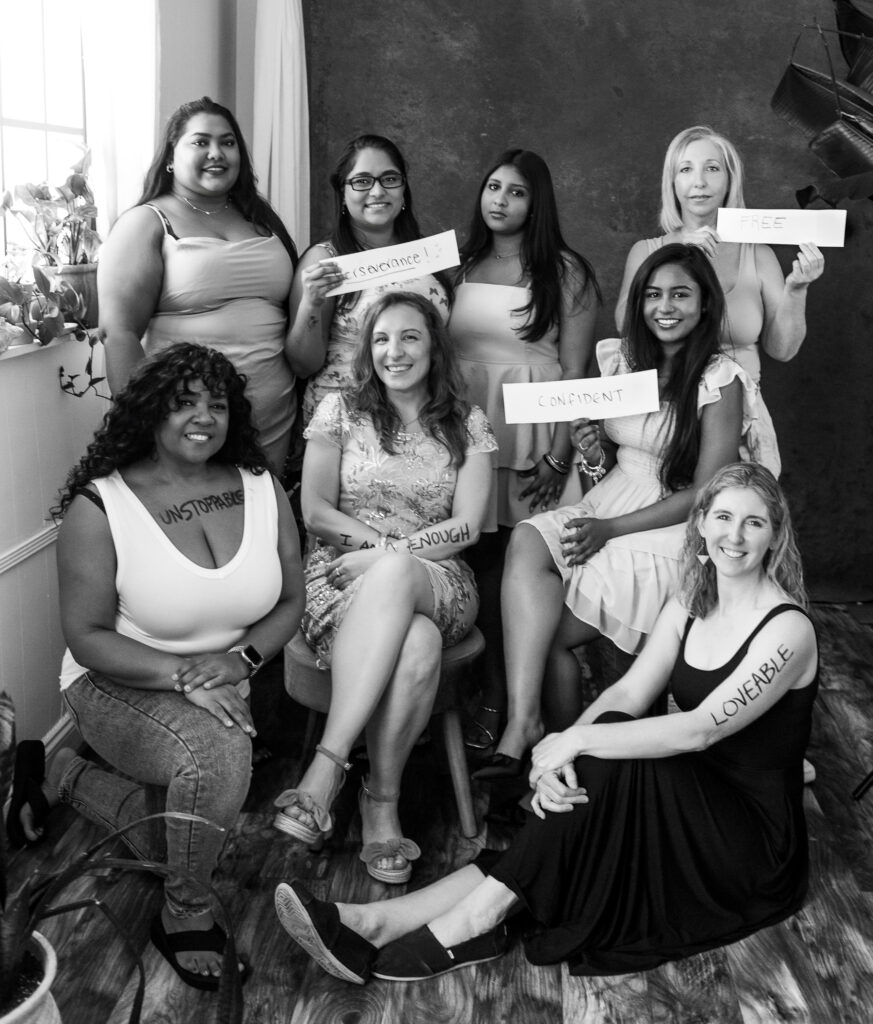 The attendees of The Worthy Project gathered together, displaying their reclaimed words on their bodies and on paper. Photography by Lindsay Hite. 